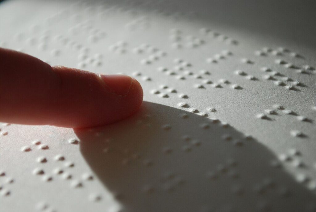 Fingers reading braille