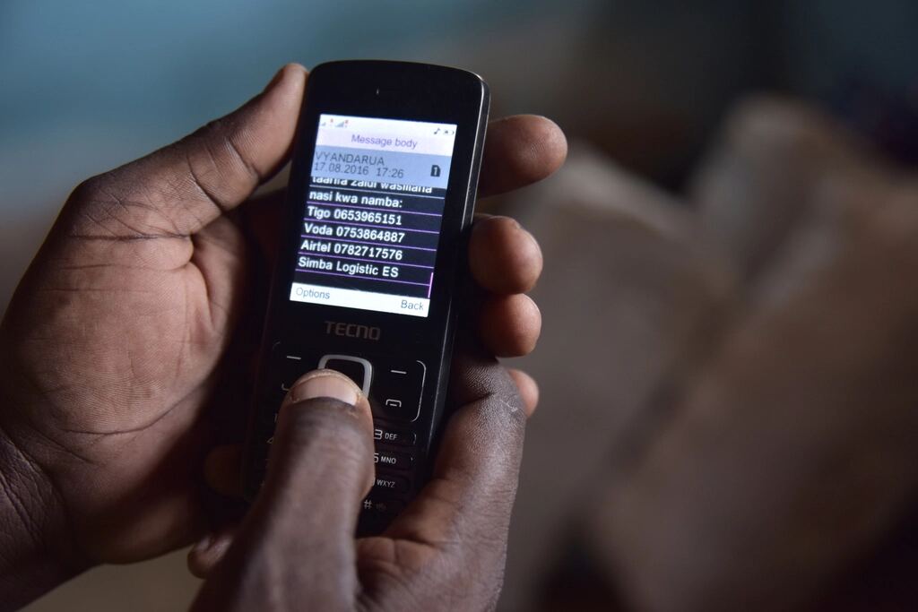 A hand holding a mobile phone